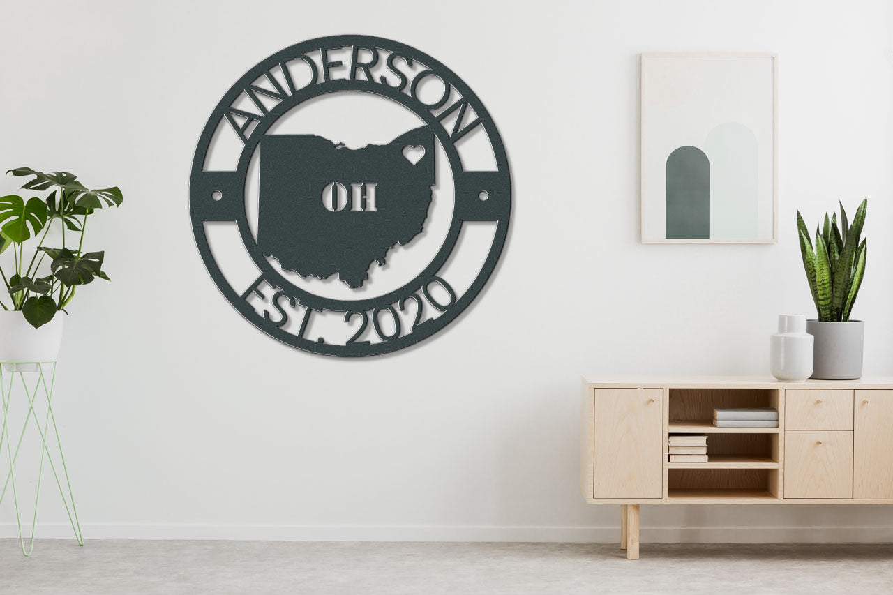 a living room with a white wall and a large metal sign