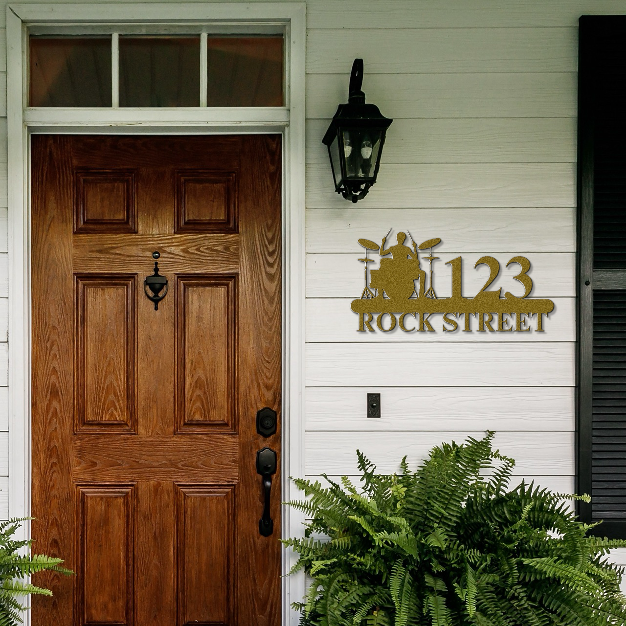 a house with a wooden door and a light on the side of it