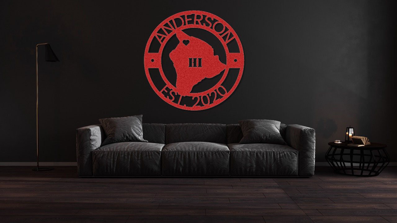 a living room with a black couch and a red logo on the wall