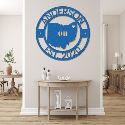 a living room with a table and a blue sign on the wall