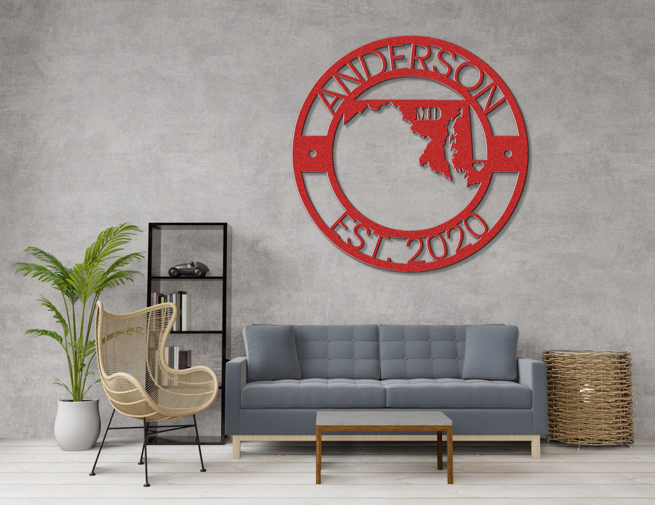 a living room with a gray couch and a red metal wall clock