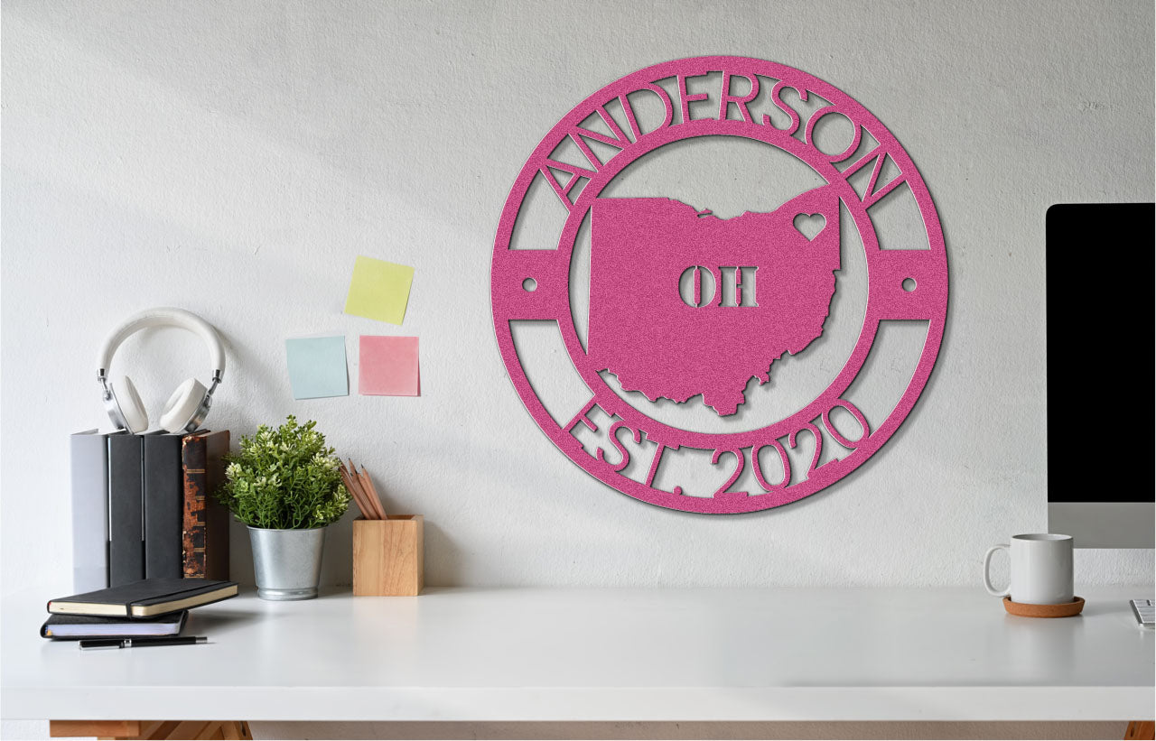 a white desk topped with a computer and a pink sign