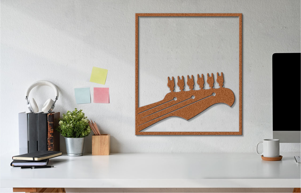 a white desk topped with a computer monitor and a wooden cutout of a guitar