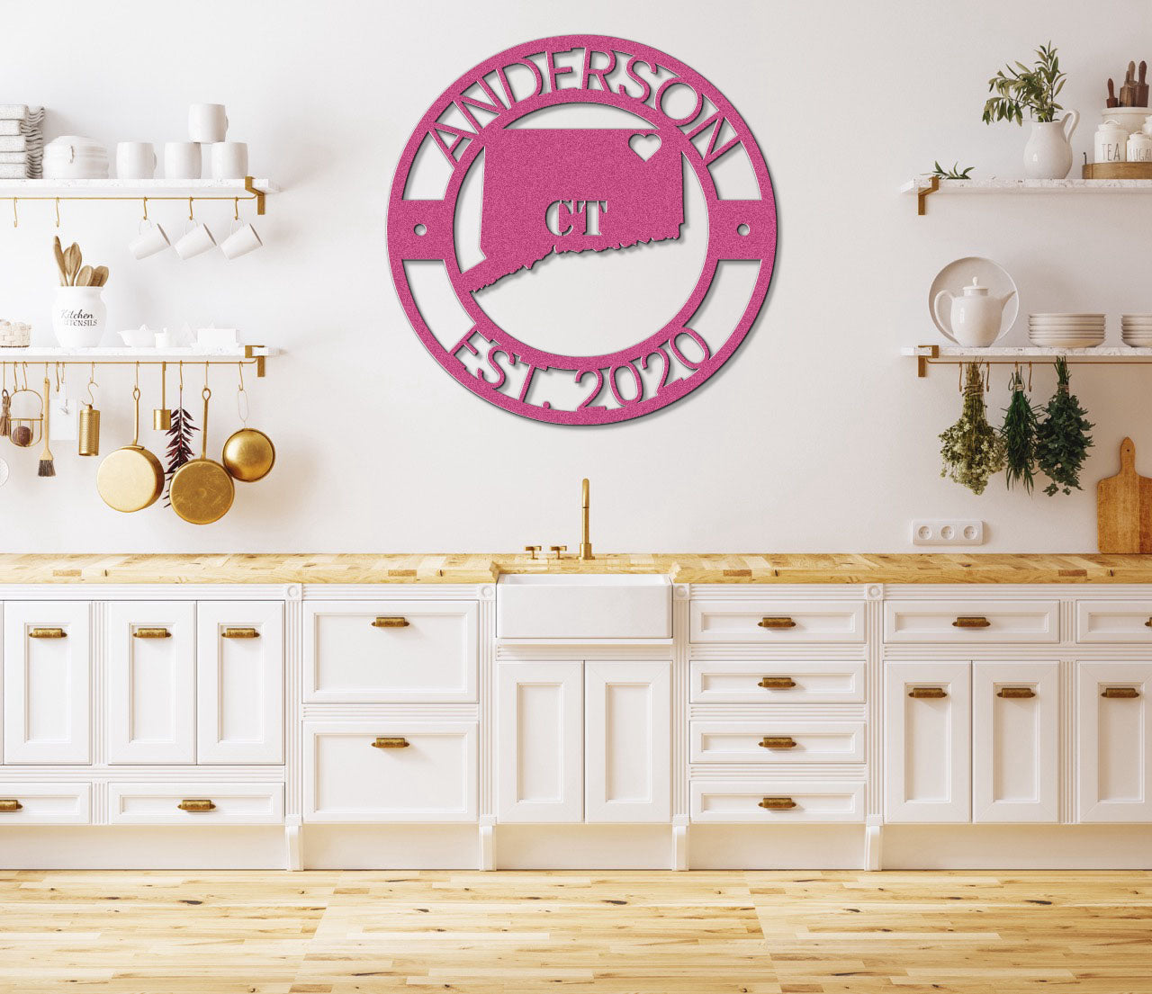 a kitchen with white cabinets and a pink clock