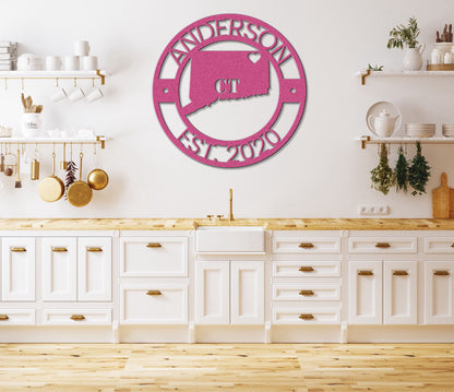 a kitchen with white cabinets and a pink clock