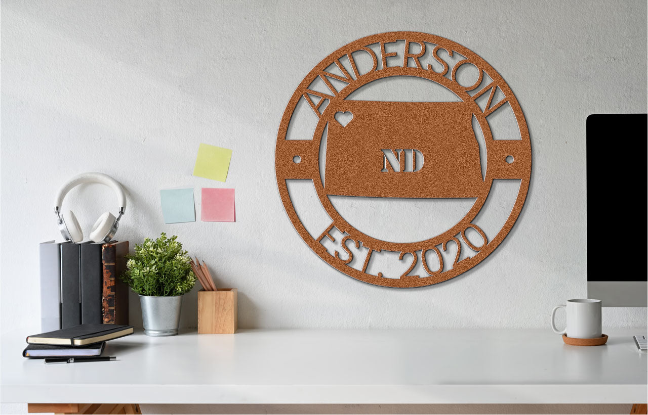 a white desk topped with a computer and a wooden sign