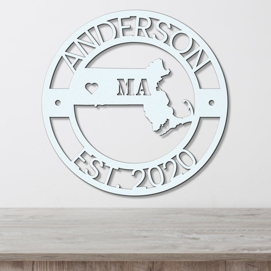 a metal sign with the name and map of the state of massachusetts