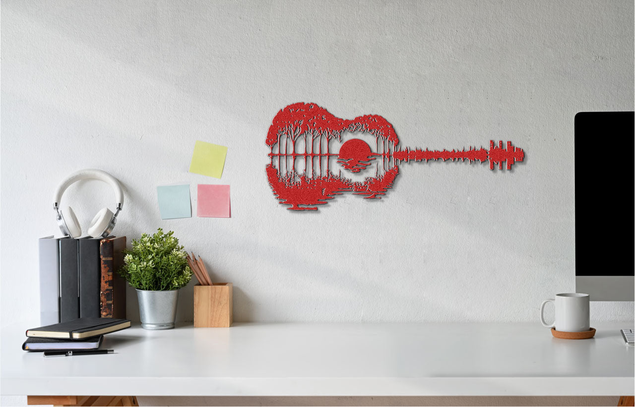 a guitar shaped wall hanging on a wall next to a computer