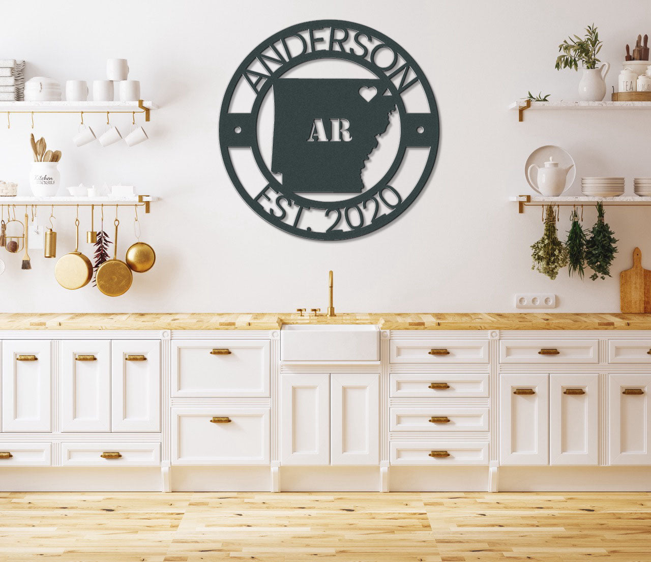 a kitchen with white cabinets and a large metal wall clock