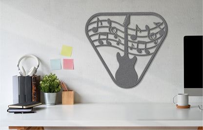 a guitar wall hanging on a wall next to a computer