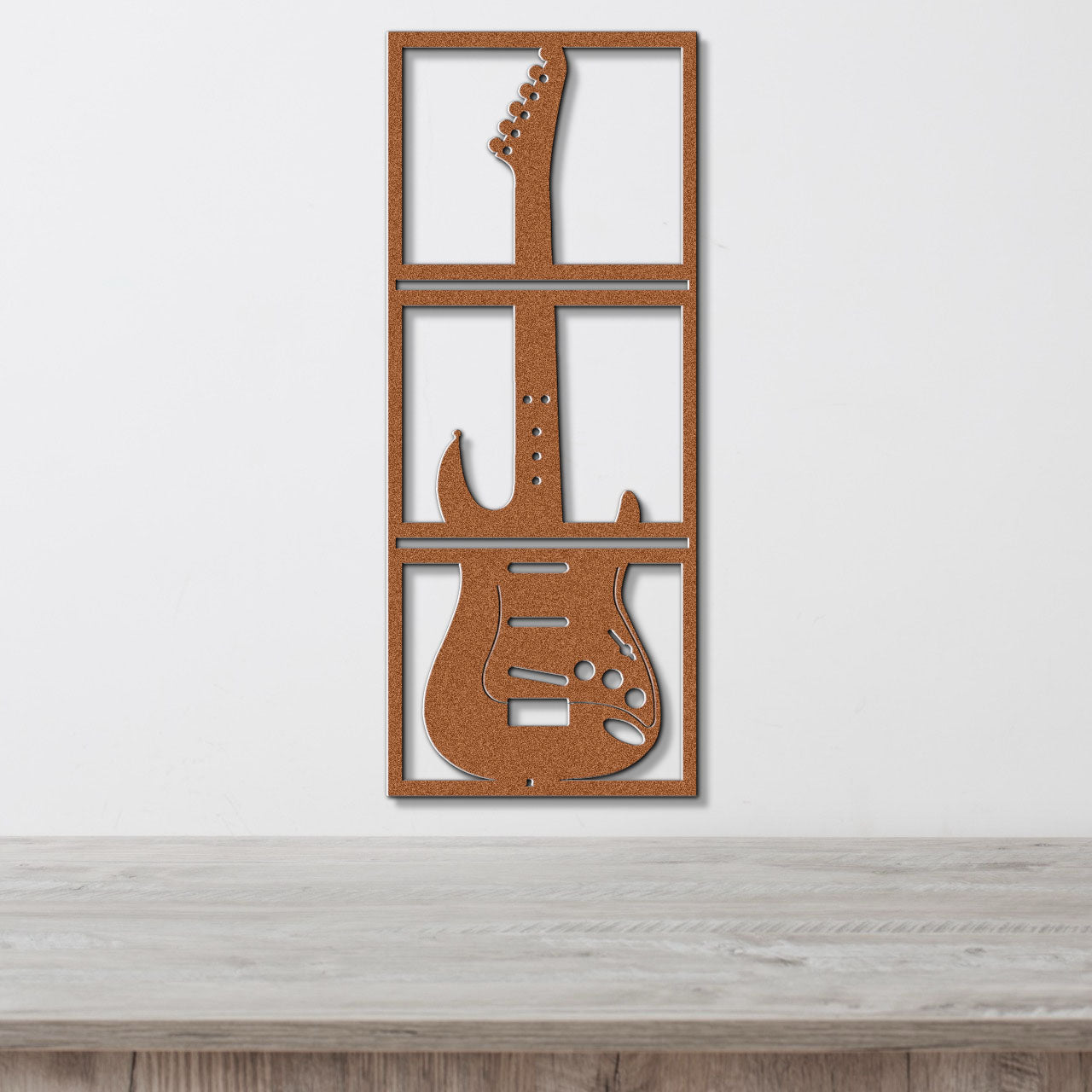 a guitar cut out of wood sitting on top of a table