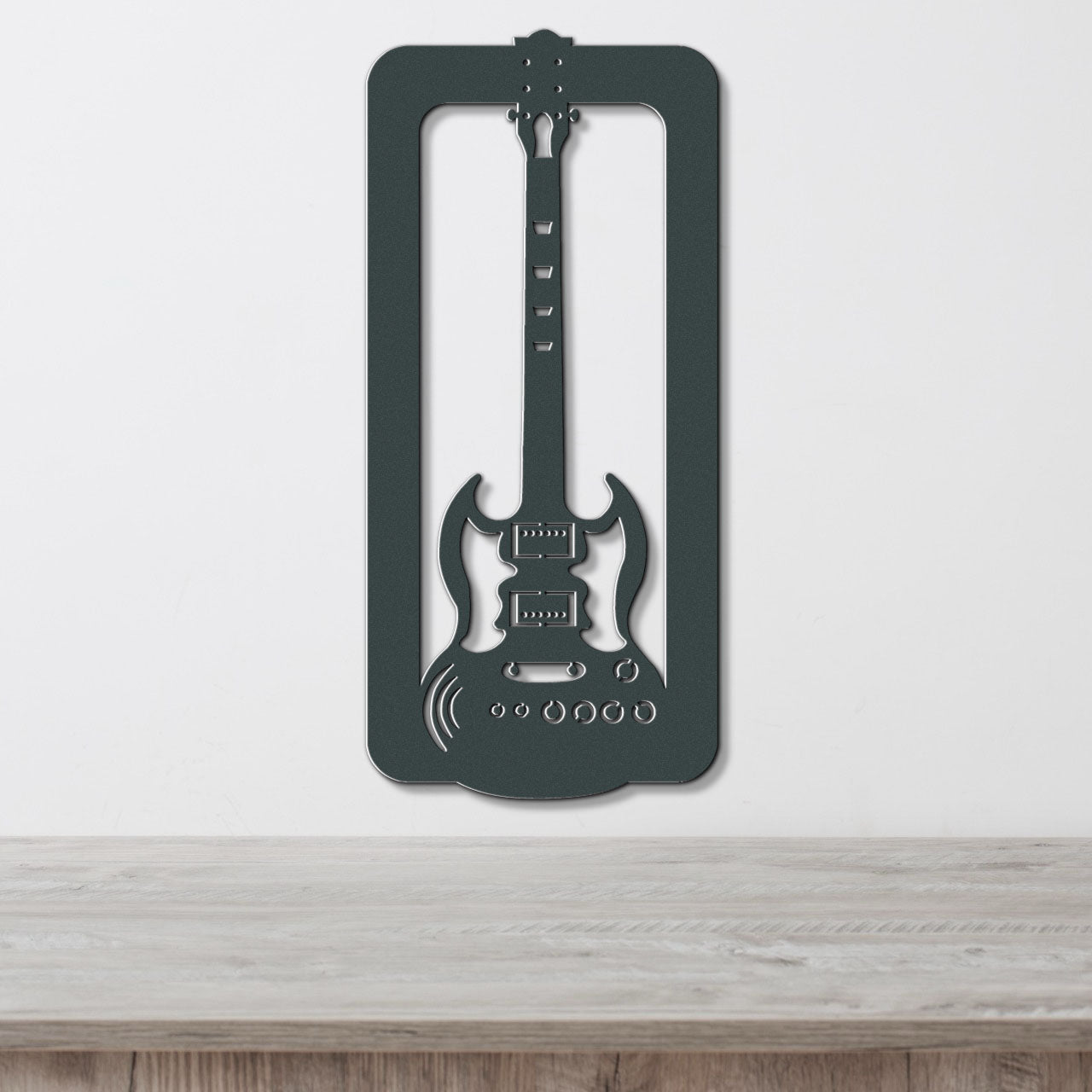 a guitar shaped like a frame hanging on a wall