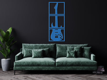 a living room with a green couch and a guitar wall decal