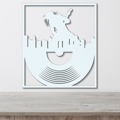 a paper cut of a man on top of a record player