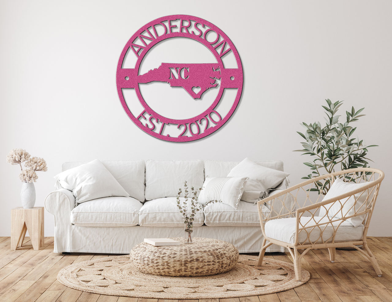 a living room with a white couch and a pink sign