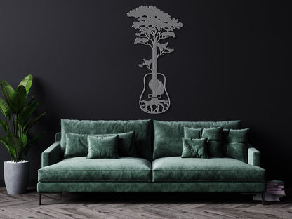 a living room with a green couch and a guitar on the wall