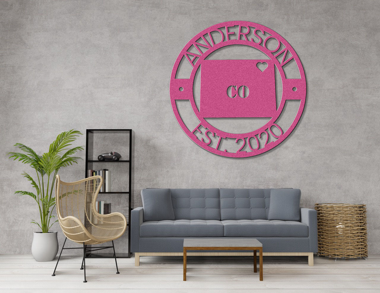 a living room with a gray couch and a pink clock